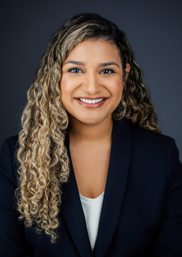 Confident approachable businesswoman professional headshot dark background New Jersey by Alex Kaplan