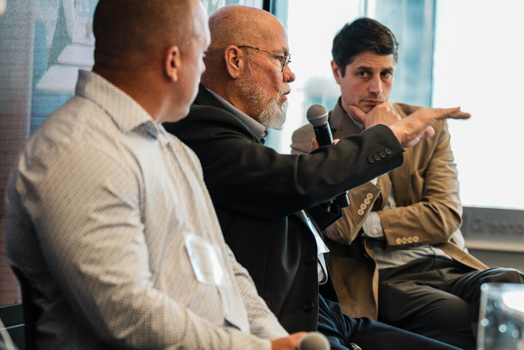 Richard Ludt speaking on stage with other panelists at Climate Week NYC, captured by Alex Kaplan Photography.