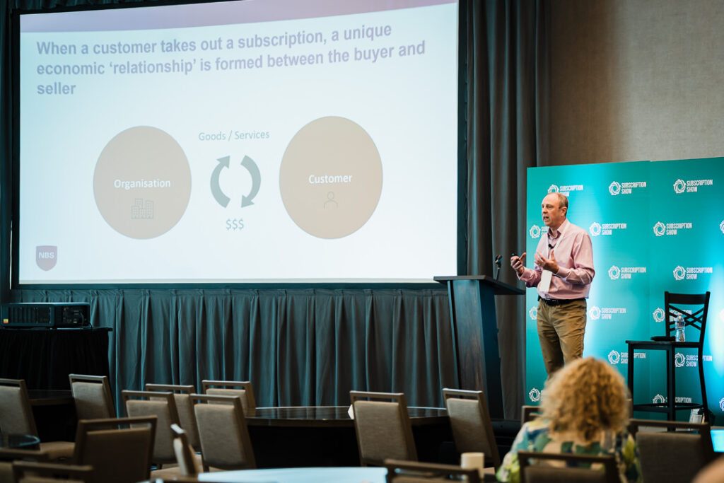 speaker-presenting-data-slides-at-corporate-meeting-by-alex-kaplan-photography
