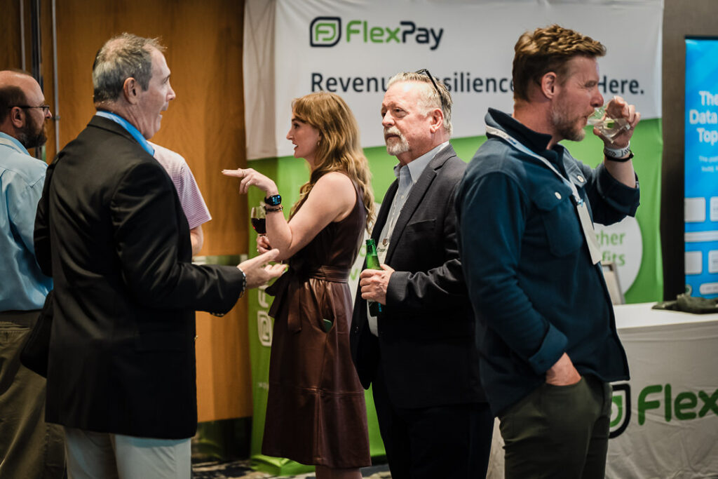 flexpay-booth-team-discussing-revenue-resilience-solutions-by-alex-kaplan-photography