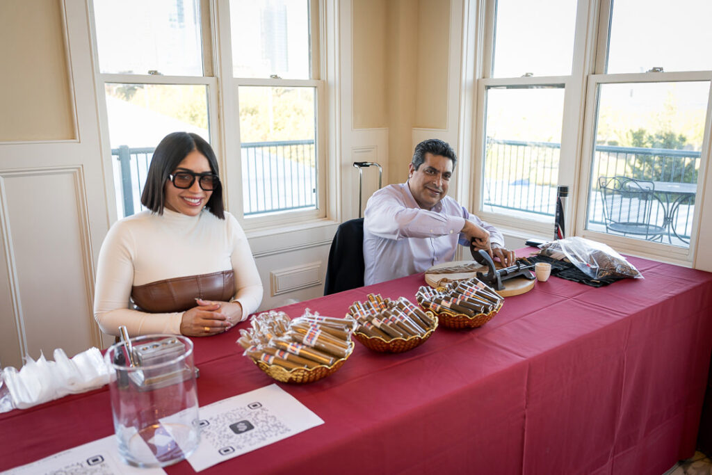 Two people staffing cigar distribution table at Tilcon New York corporate event