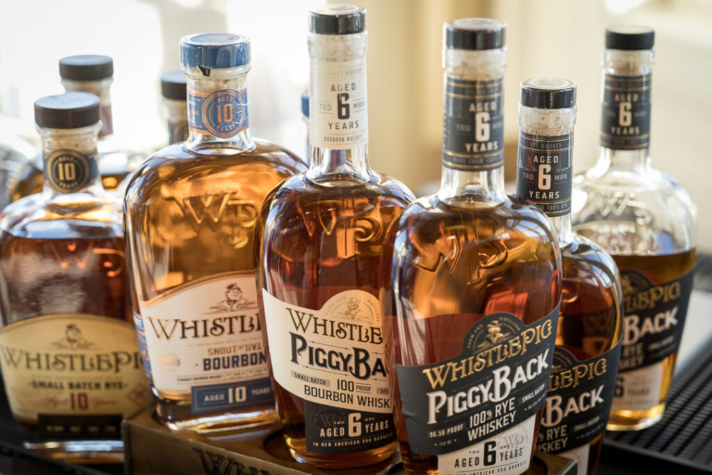 Premium WhistlePig bourbon and whiskey bottles displayed at Tilcon New York corporate event