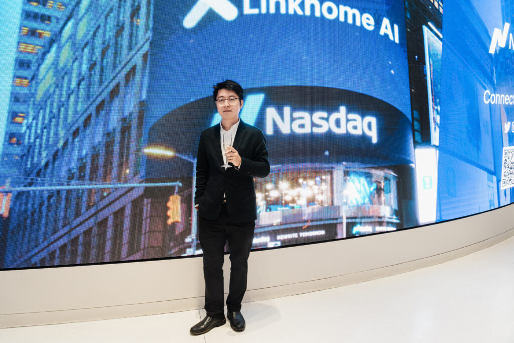 Linkhome AI executive celebrating Nasdaq IPO with LED screens displaying company branding corporate photography