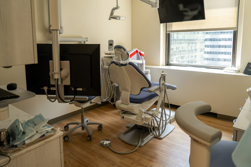 Detail view of modern blue dental chair with overhead LED lighting and professional dental instruments at Canopy Dentistry, medical equipment photography by Alex Kaplan