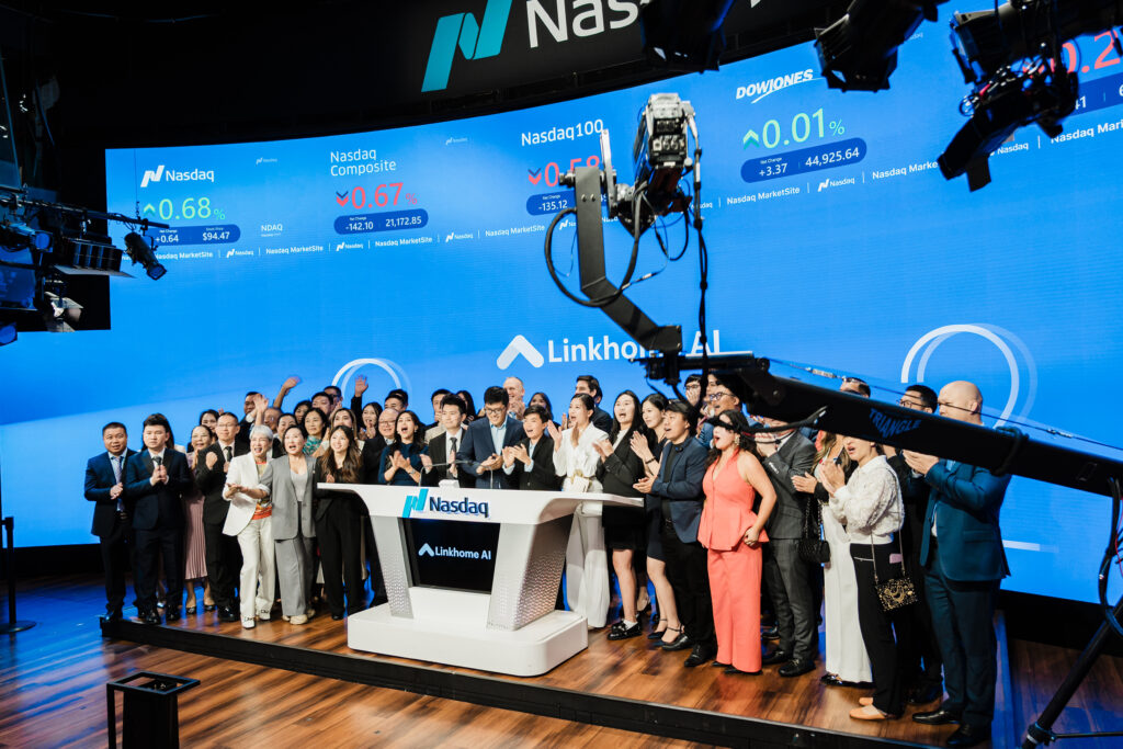 Linkhome AI team celebrating at Nasdaq bell-ringing ceremony with executives gathered at podium
