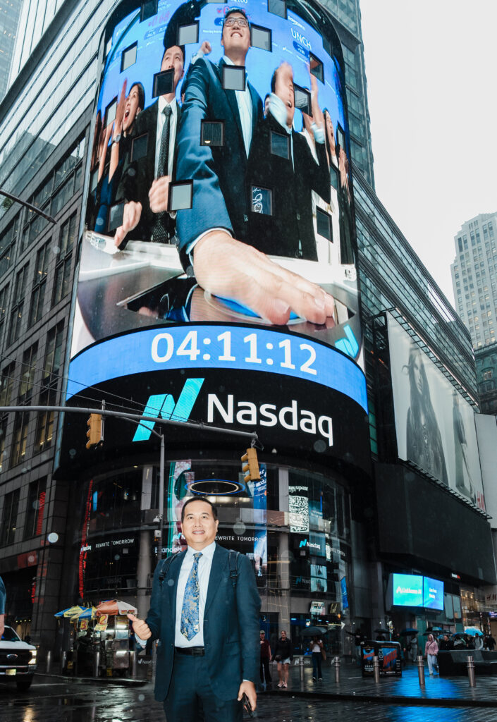 Executive posing in front of Nasdaq tower with Linkhome AI bell-ringing broadcast
