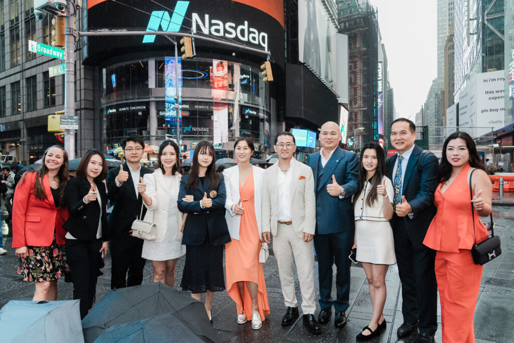 Linkhome AI guests and leadership posing in Times Square with Nasdaq tower in background