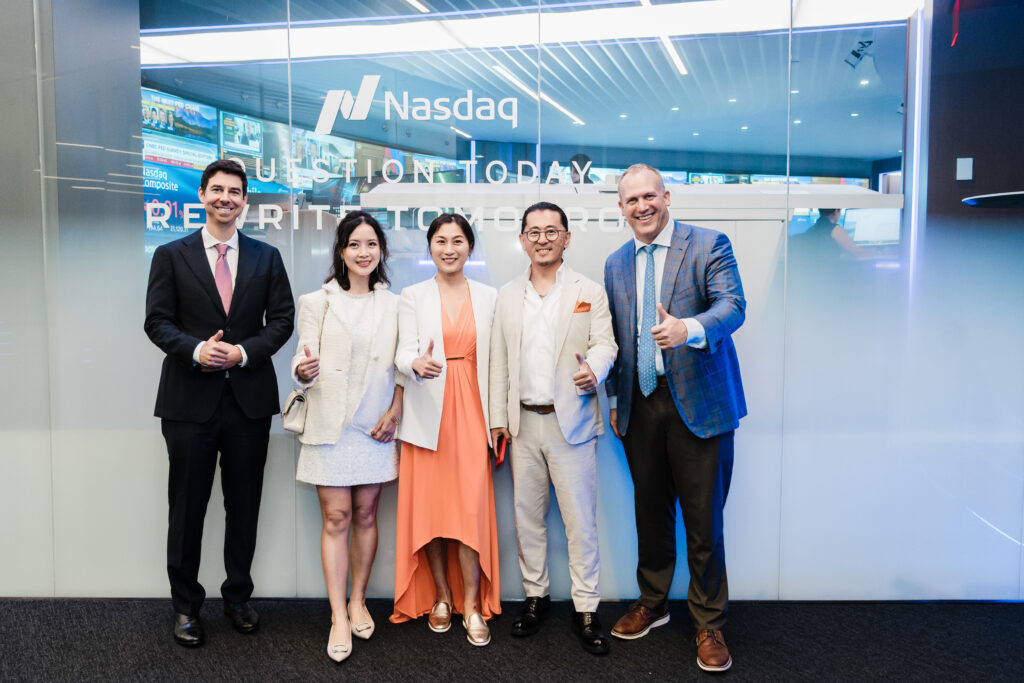 Executive speaking at Nasdaq podium Linkhome AI IPO event Times Square professional photographer