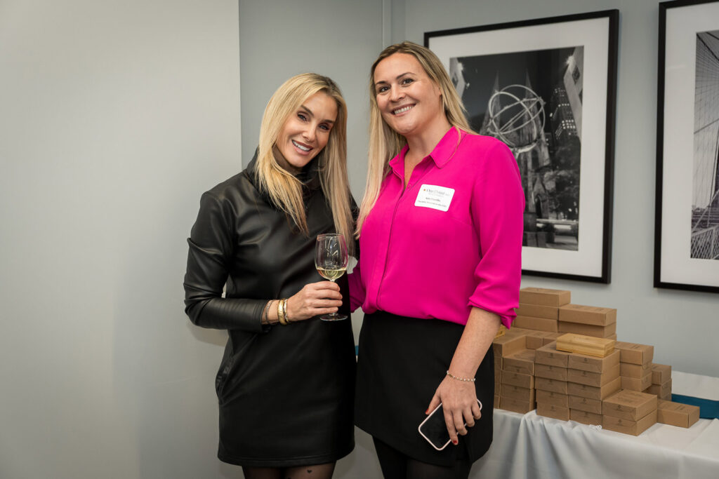 Event attendees mingling at OnePoint BFG Parsippany office during wine tasting