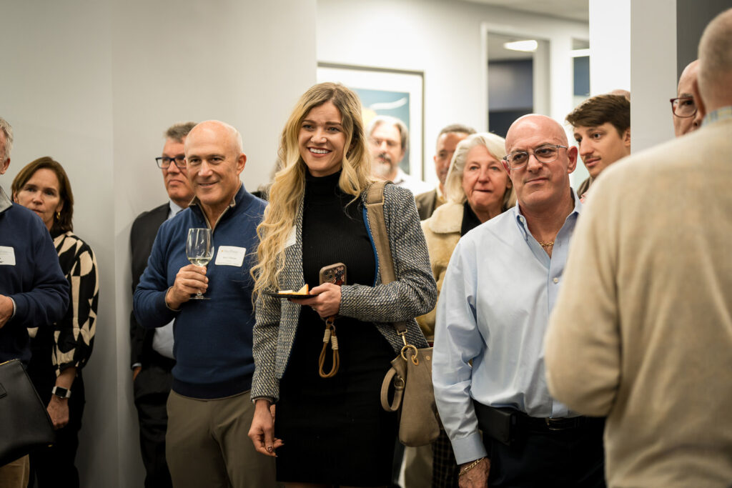 Professional colleagues enjoying wine and conversation at corporate event