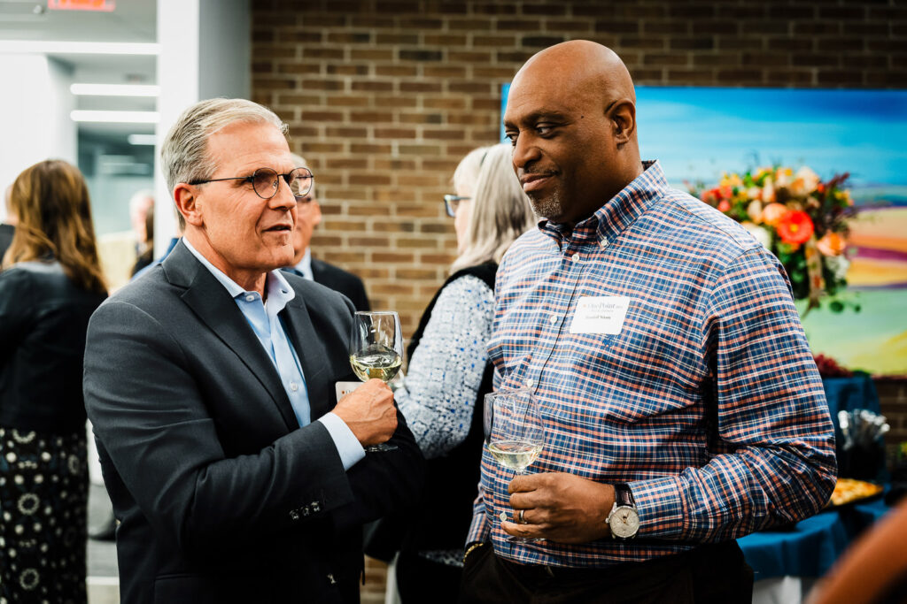 Group of financial advisors and clients networking at New Jersey corporate event