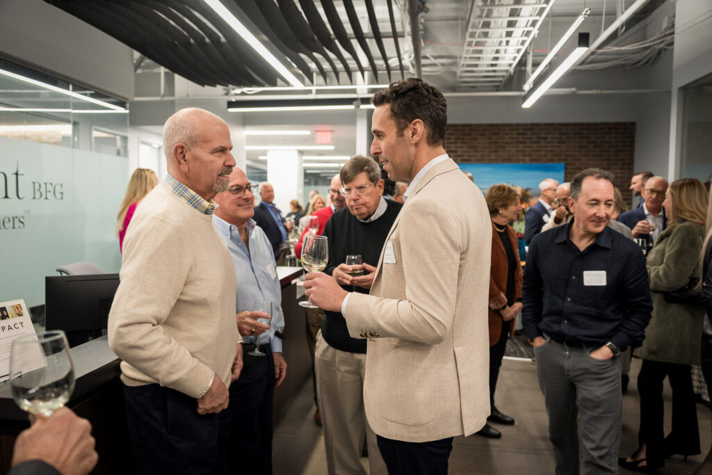Diverse group of professionals networking at OnePoint BFG wealth management event