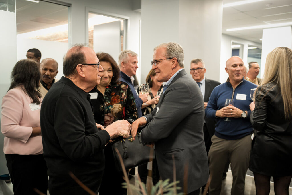 Business professionals shaking hands at OnePoint BFG networking event in New Jersey