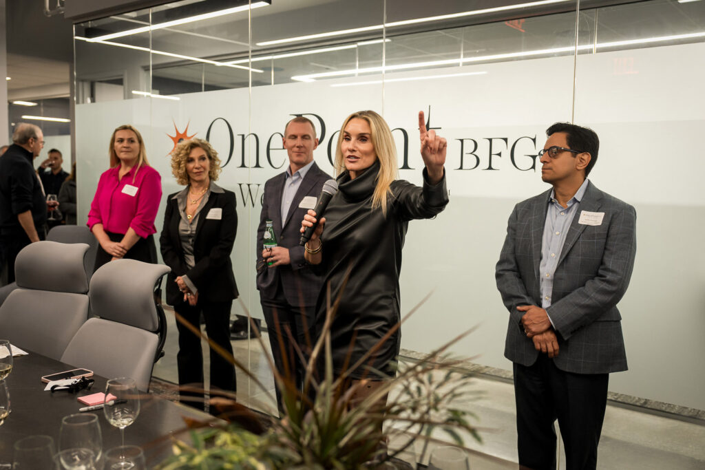 OnePoint BFG leadership team presenting to clients and partners at corporate event