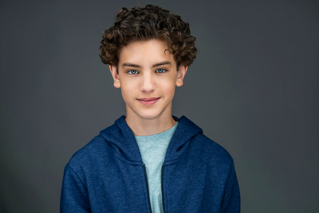 Actor Maximo Masefield headshot in blue hoodie by Northern NJ photographer Alex Kaplan
