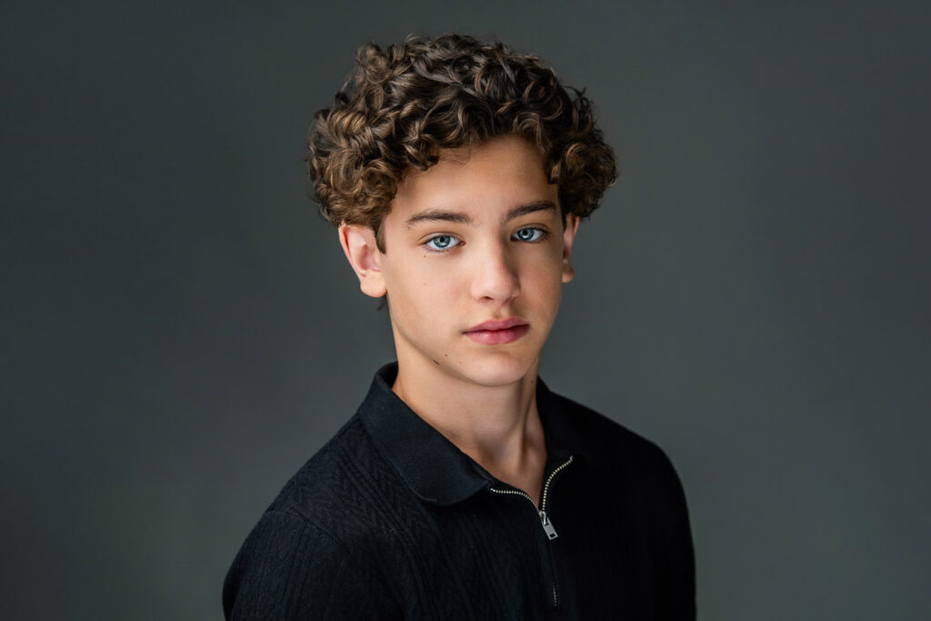 Dramatic actor headshot of Maximo Masefield in black zip-up by New Milford photographer Alex Kaplan