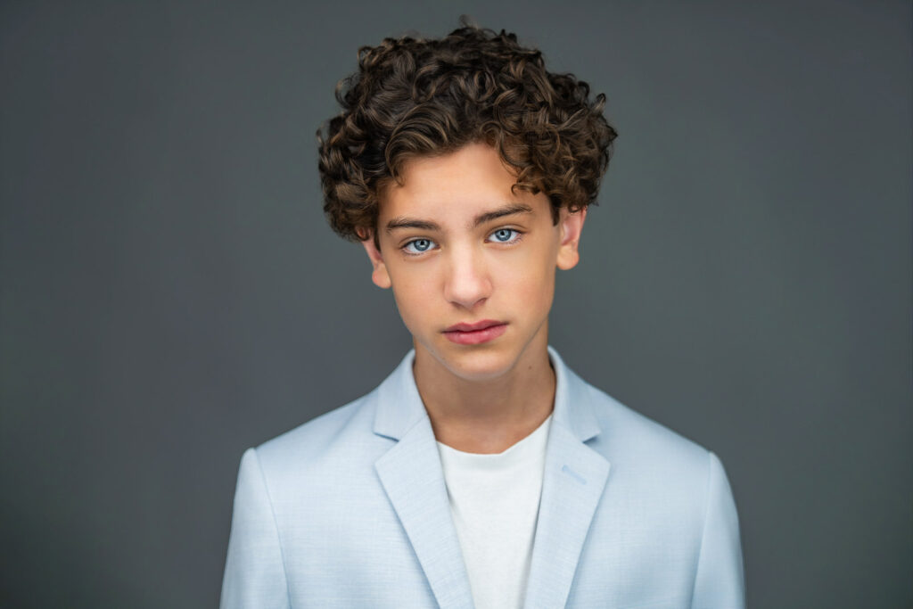 Polished professional actor headshot of Maximo Masefield in light blue blazer by Alex Kaplan Photography Northern NJ