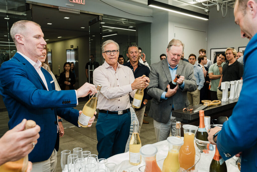 Champagne bottles and glasses at OnePoint brand launch celebration