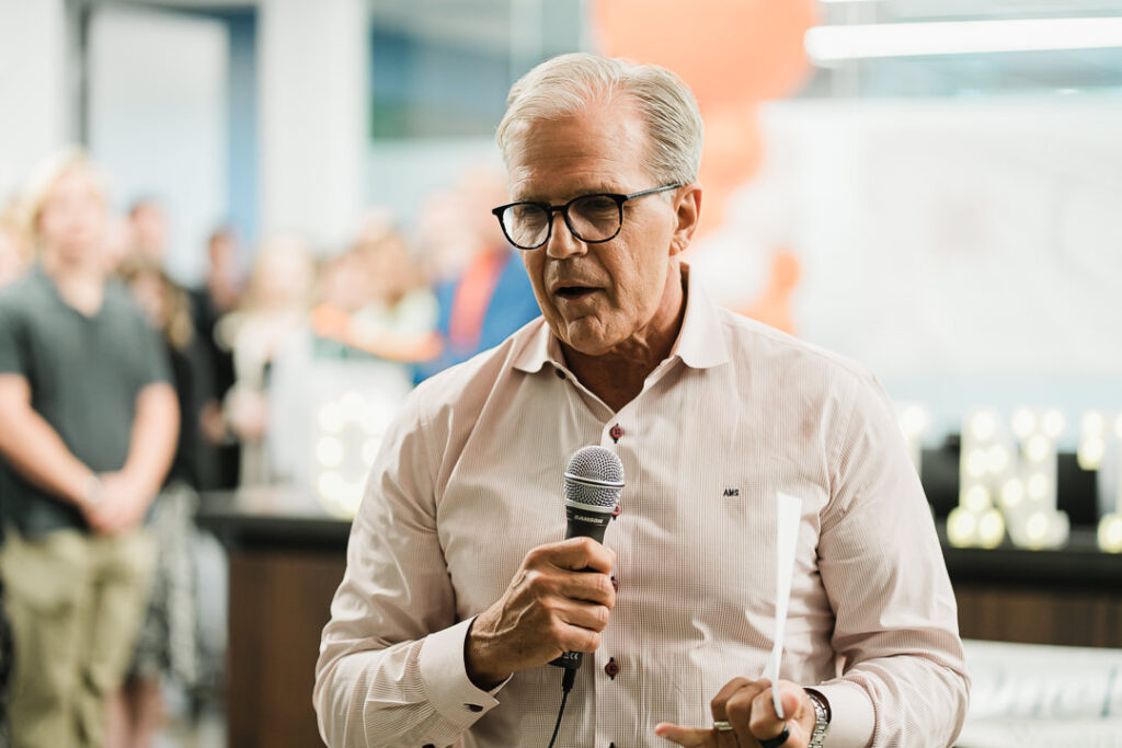 Senior advisor at OnePoint discussing company vision during brand launch event