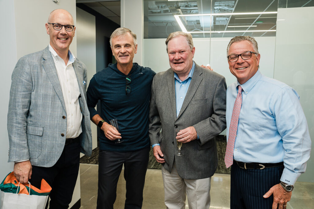 Senior partners at OnePoint celebrating company rebrand and future growth