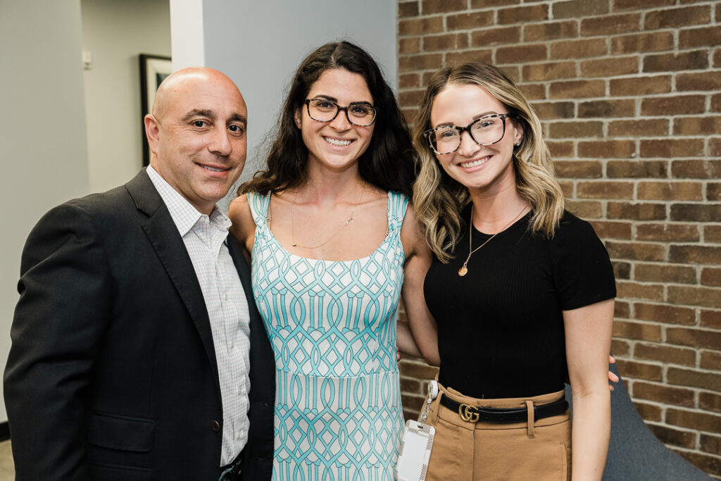 OnePoint team members building relationships at brand launch