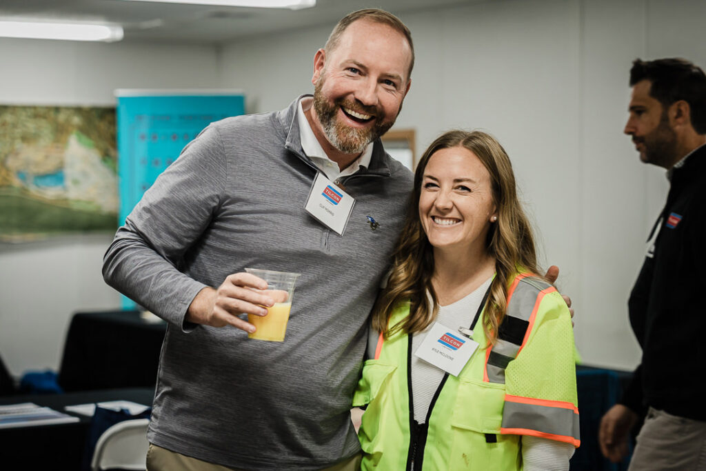 Tilcon CEO greets team member at Clinton Point Quarry, safety vests and name tags visible