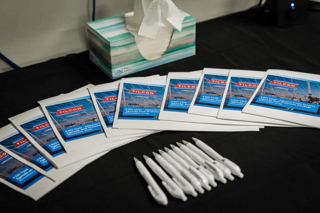 CEO visit materials including Tilcon branded booklets, pens, tissues and name tags laid out on table