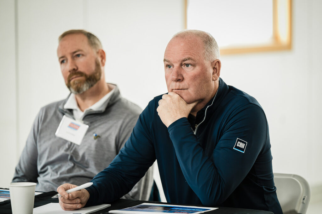 Two Tilcon executives in business attire listening during Clinton Point Quarry strategic meeting