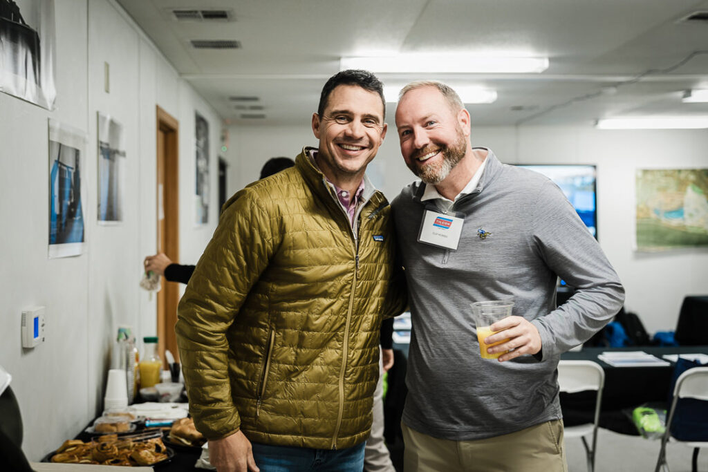 Two Tilcon executives in business casual attire networking at Clinton Point Quarry CEO visit event