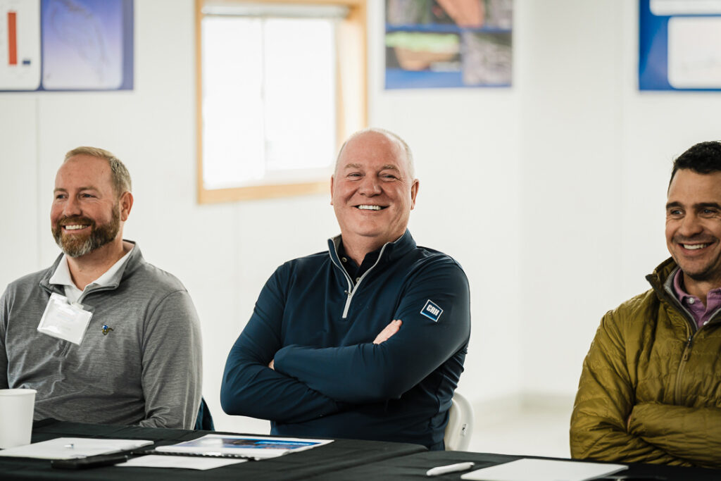 Three Tilcon executives smiling during indoor meeting at Clinton Point Quarry CEO visit
