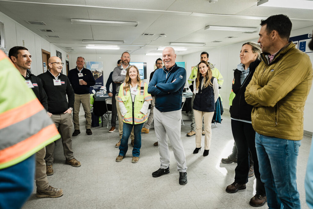 Large group of Tilcon team members in safety gear gathered for photo at Clinton Point Quarry during CEO visit