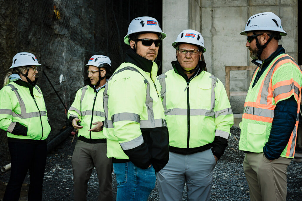 Group of Tilcon leaders in hard hats and safety vests during quarry facility tour
