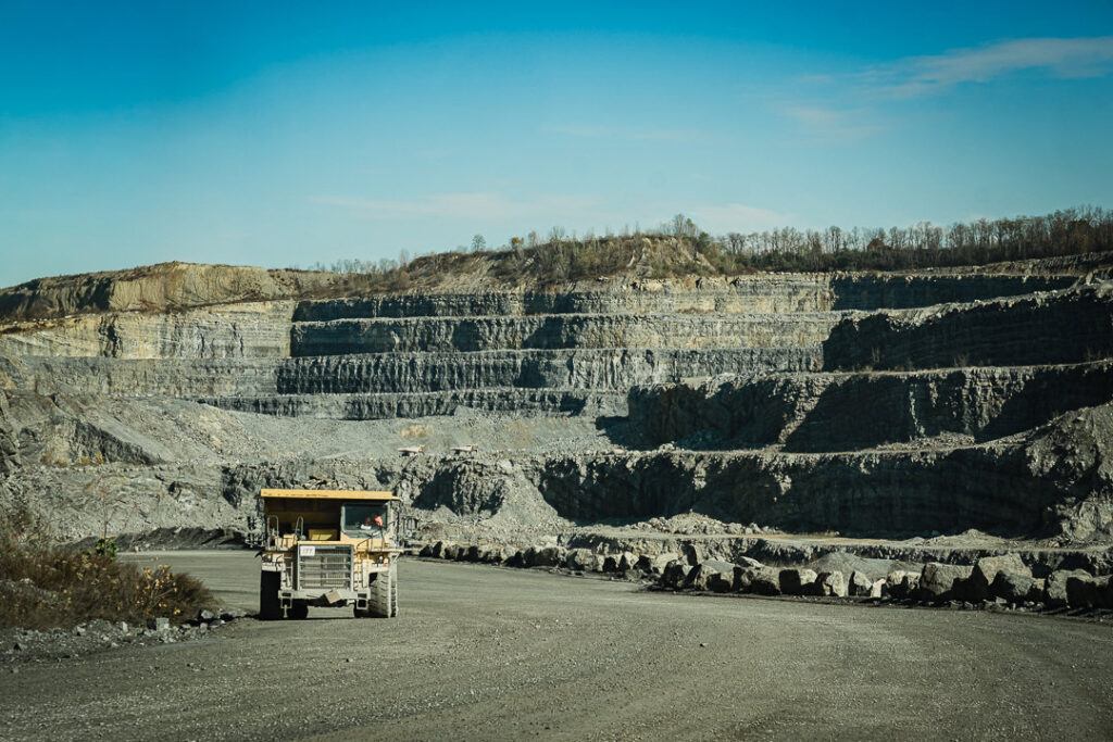 Dramatic view of Clinton Point Quarry showing terraced benches and haul truck on quarry road