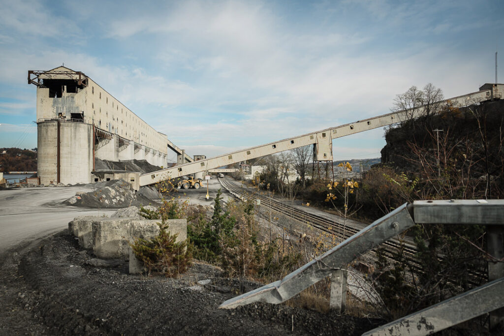 Clinton Point processing facility with conveyors and concrete towers under cloudy Hudson Valley sky