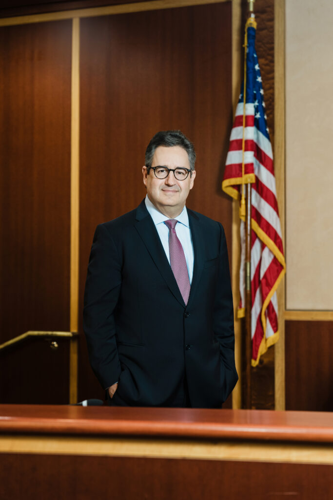 Full-length professional portrait of expert witness in New Jersey courtroom