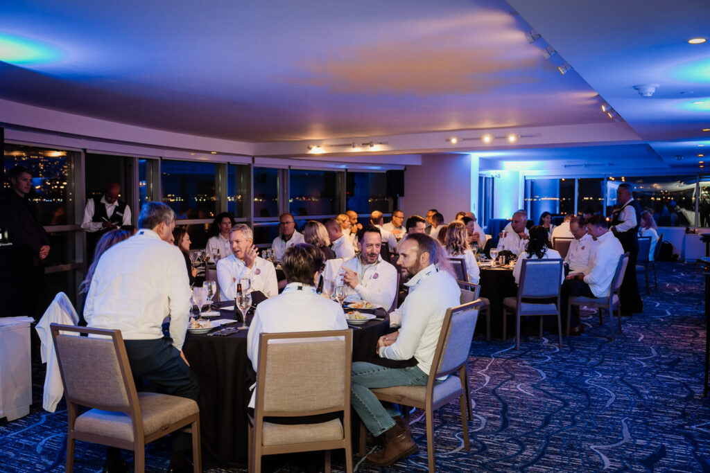 Corporate dinner reception with dramatic uplighting by Alex Kaplan