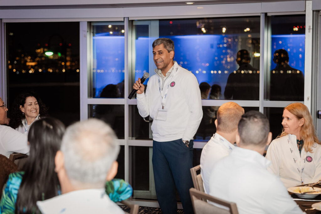 Corporate keynote speaker presenting to engaged audience by Alex Kaplan