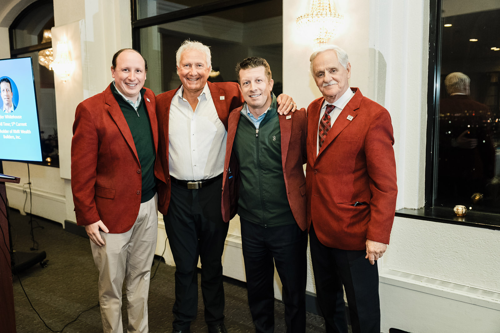 alex kaplan corporate leadership team group photo red jackets