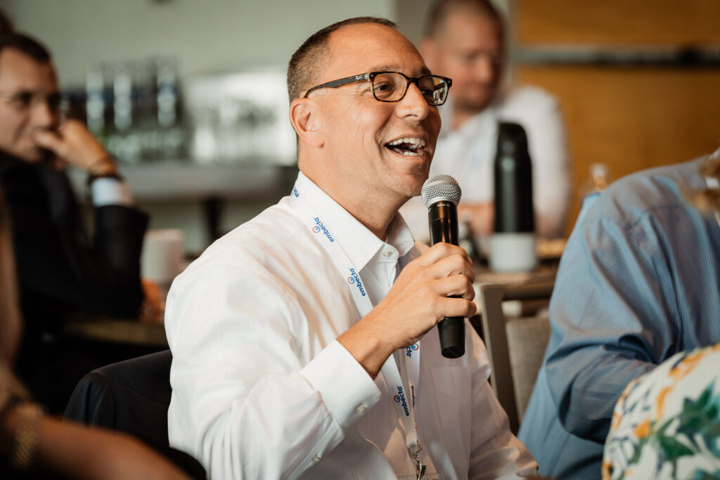 Corporate professional laughing during conference by Alex Kaplan Photography