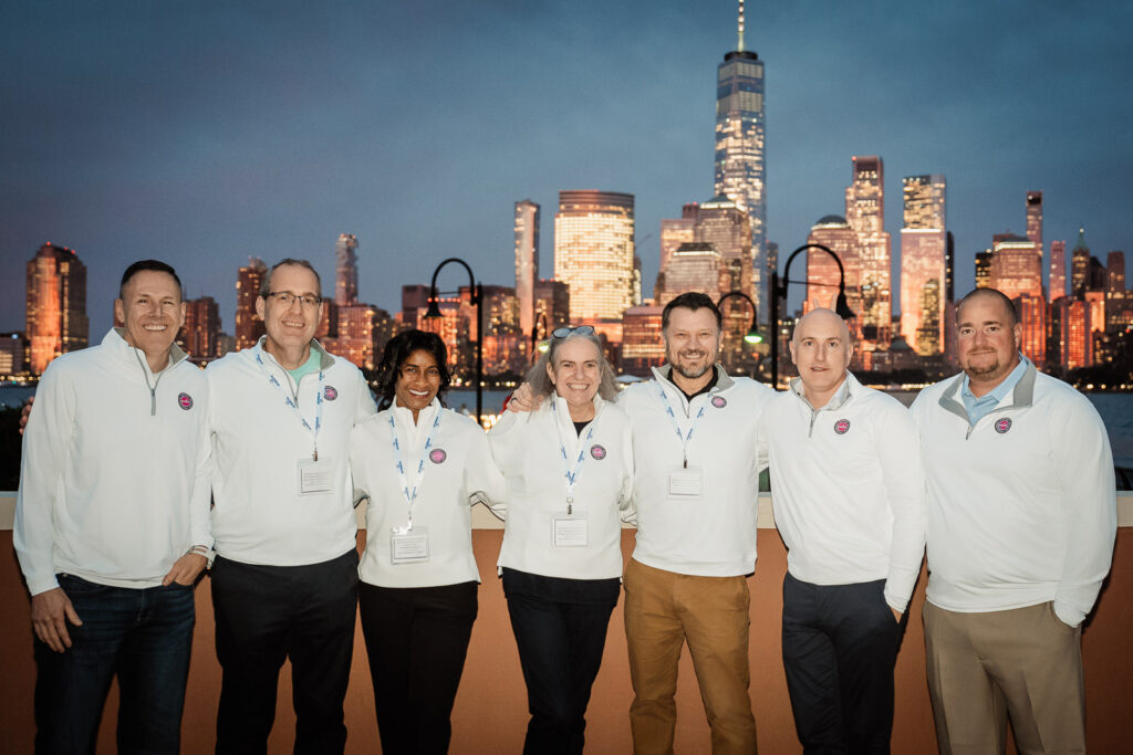 Corporate team photo during blue hour with Manhattan skyline by Alex Kaplan