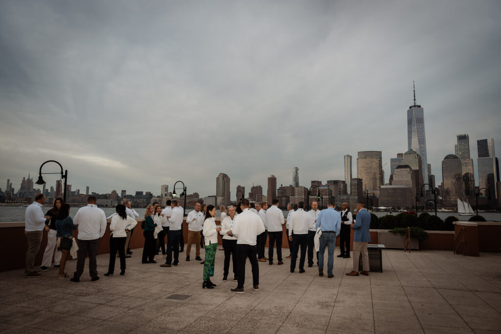 Full Embecta team group photo at sunset with NYC skyline by Alex Kaplan Photography