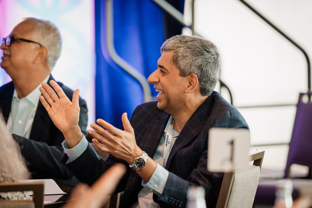 Embecta professionals in animated discussion by Alex Kaplan Photography