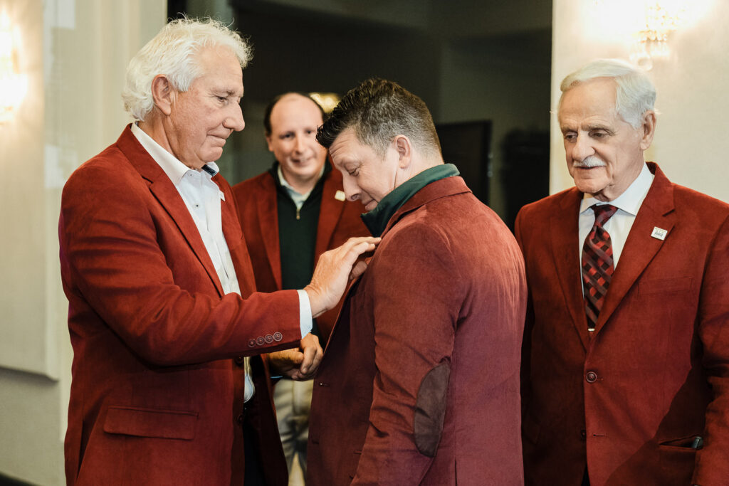 Leadership team member recognizing award recipient at corporate event photographed by Alex Kaplan