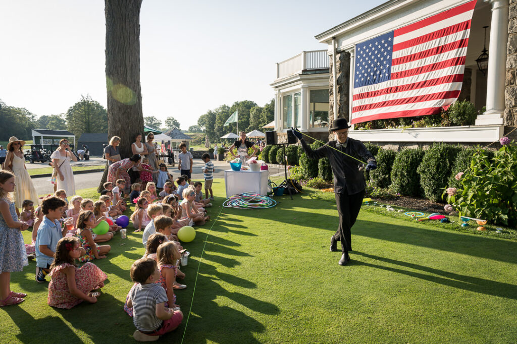 Bubble entertainer creating giant bubbles for children at The Apawamis Club photographed by Alex Kaplan