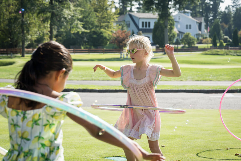  Children enjoying hula hoops on The Apawamis Club lawn photographed by Alex Kaplan