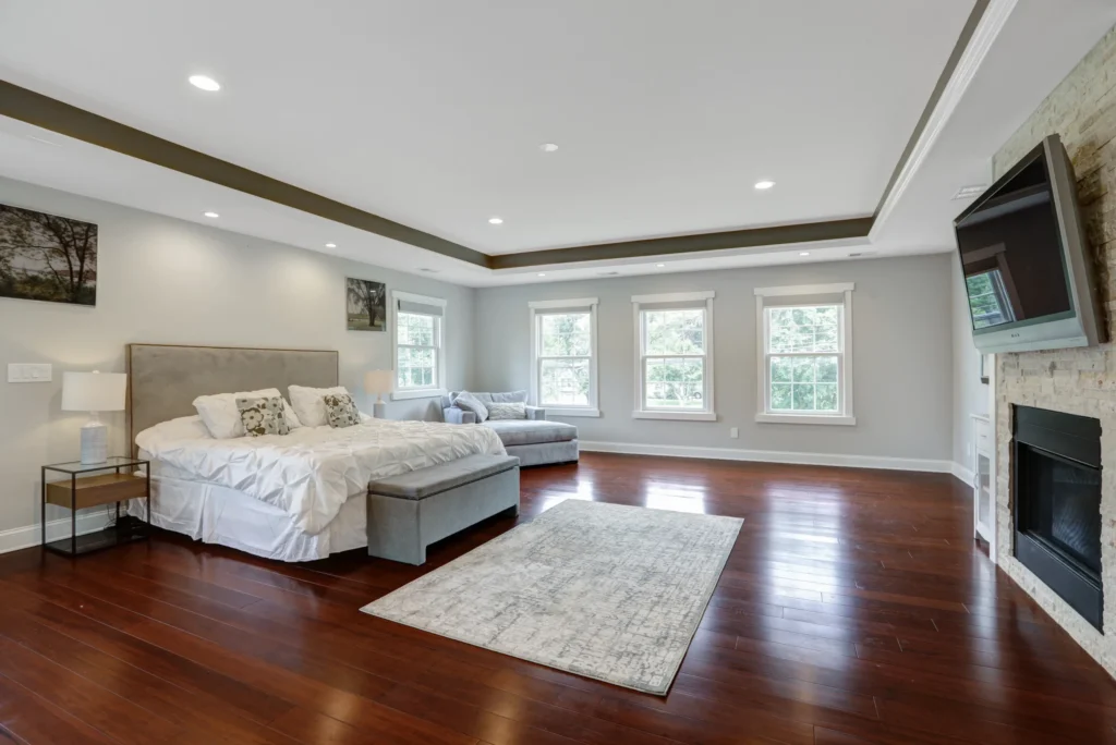 Bright master bedroom with clean bedding and natural light in Bergen County home
