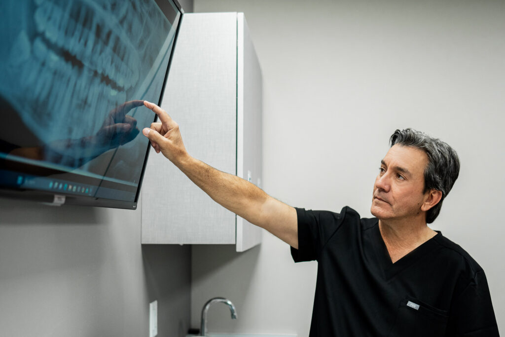 Oral surgeon reviewing imaging in a modern New Jersey office