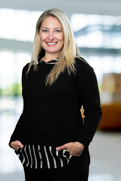 Professional businesswoman headshot with modern office background showing confidence and approachability for LinkedIn and corporate branding in New York and New Jersey