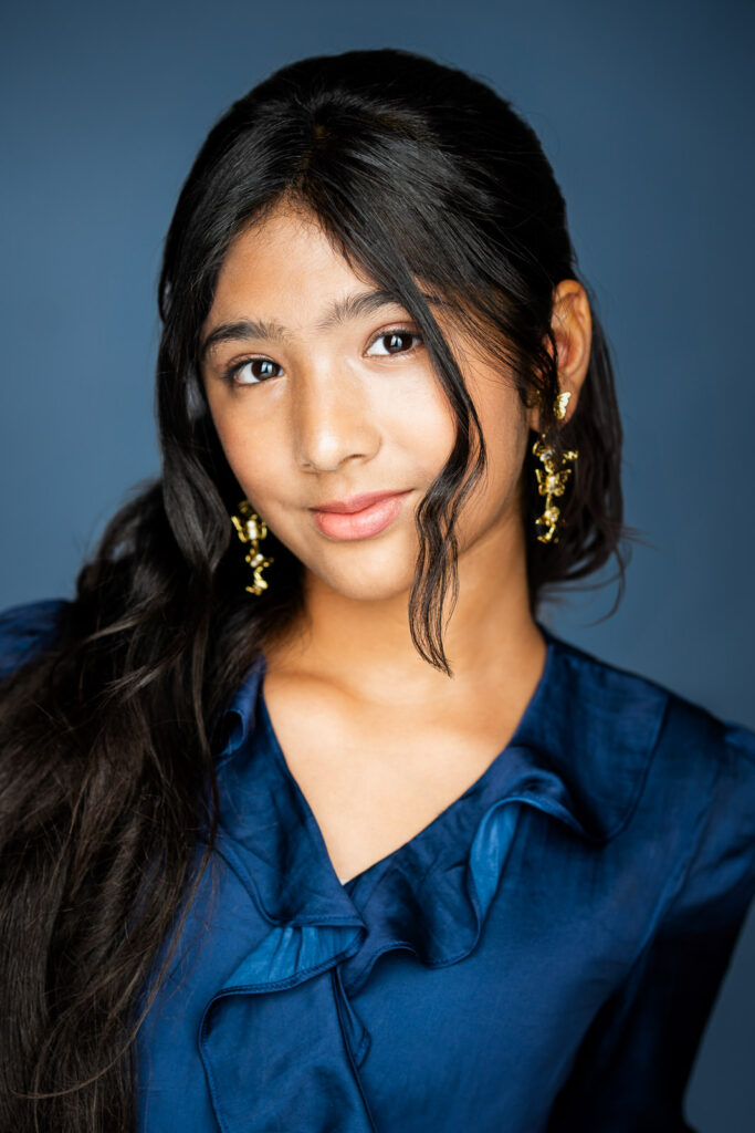  Theatrical actor headshot with blue background and expressive lighting used for stage, film, and character-driven roles
