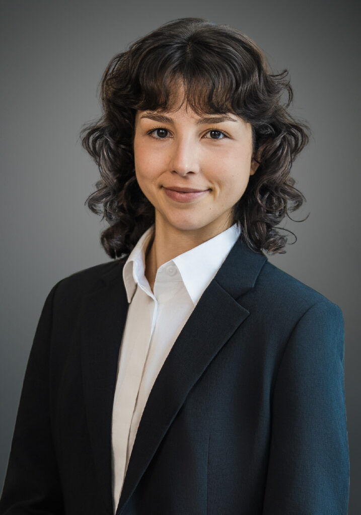 Bianca Perez's updated professional headshot in a navy blazer against a gray background